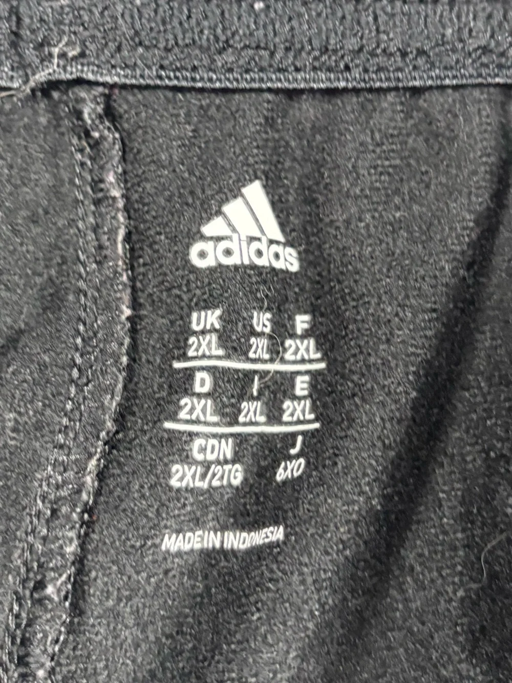 Adidas black track pants with white stripes